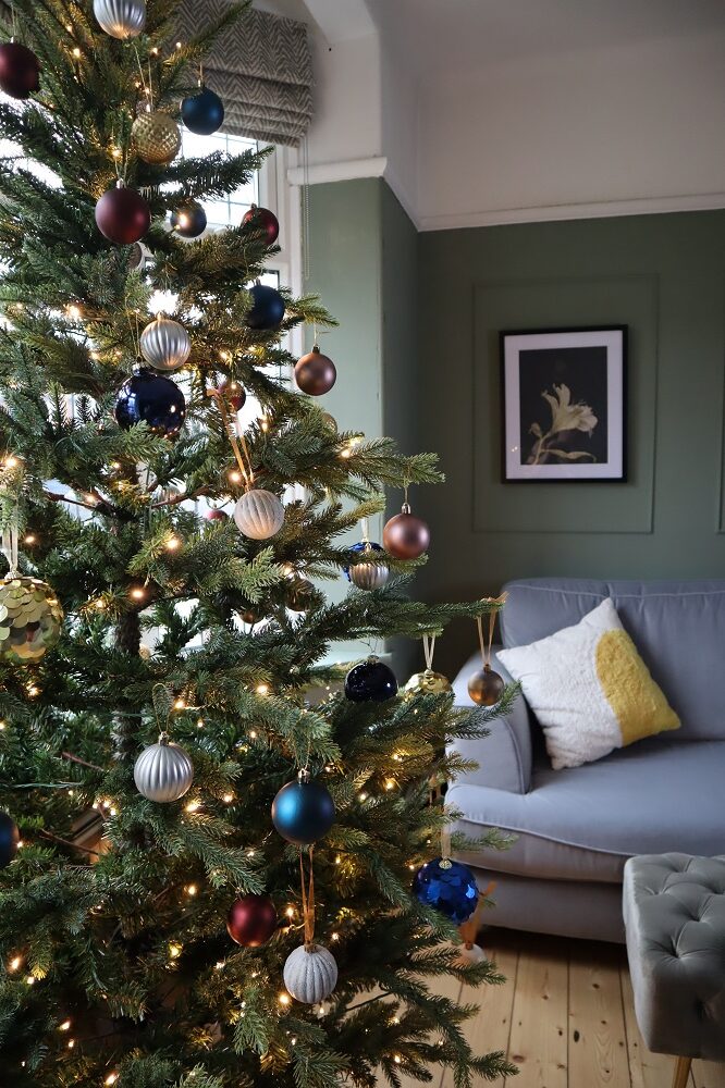 Decorating a Christmas Tree in a Bay Window